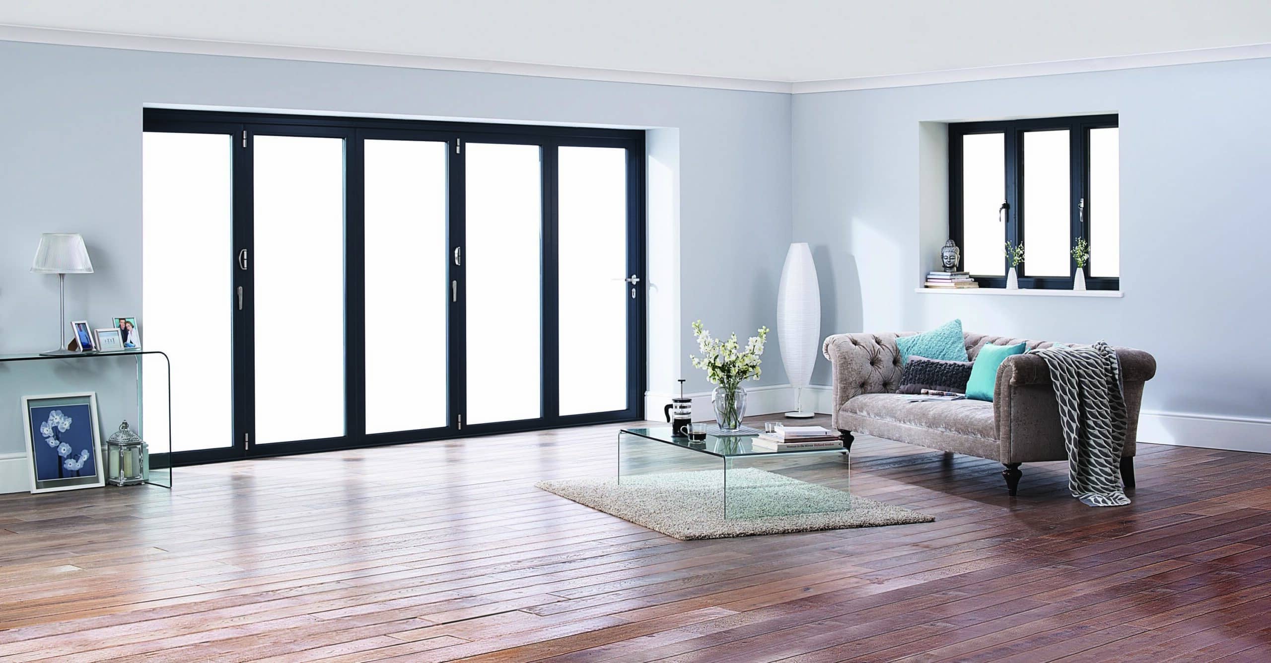 origin windows beside matching black bifold doors in a lounge