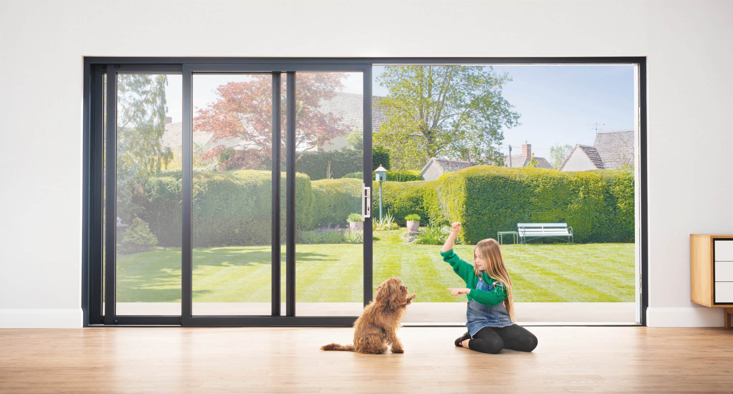 child with dog in front or open origin sliding doors