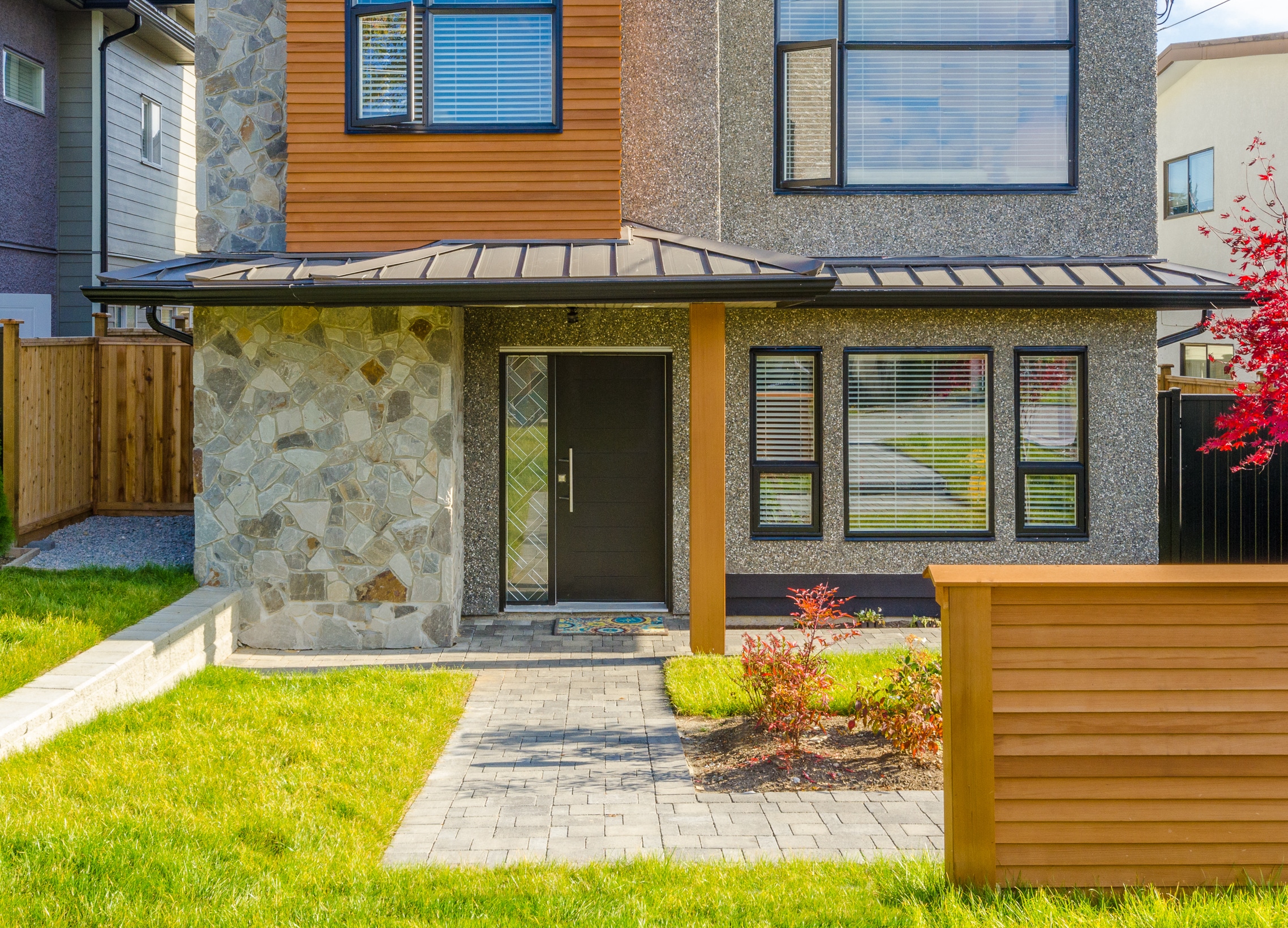 trade supply aluminium windows fitted in a stone-clad house