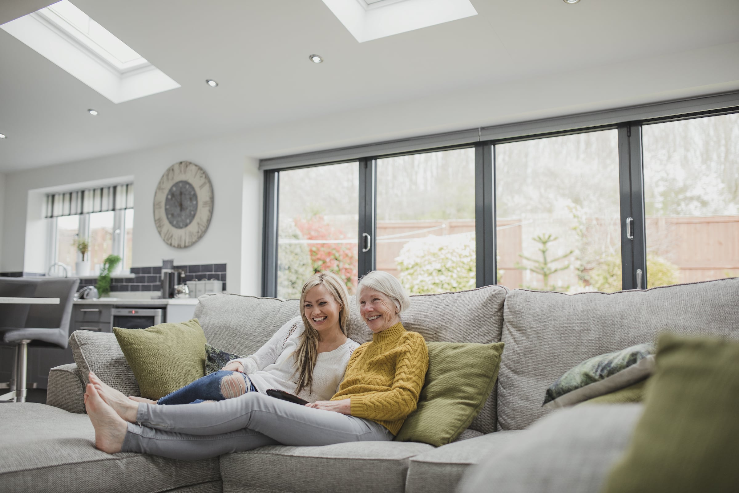 Exlabesa Xlafold bifold doors in grey with couple on a sofa in front