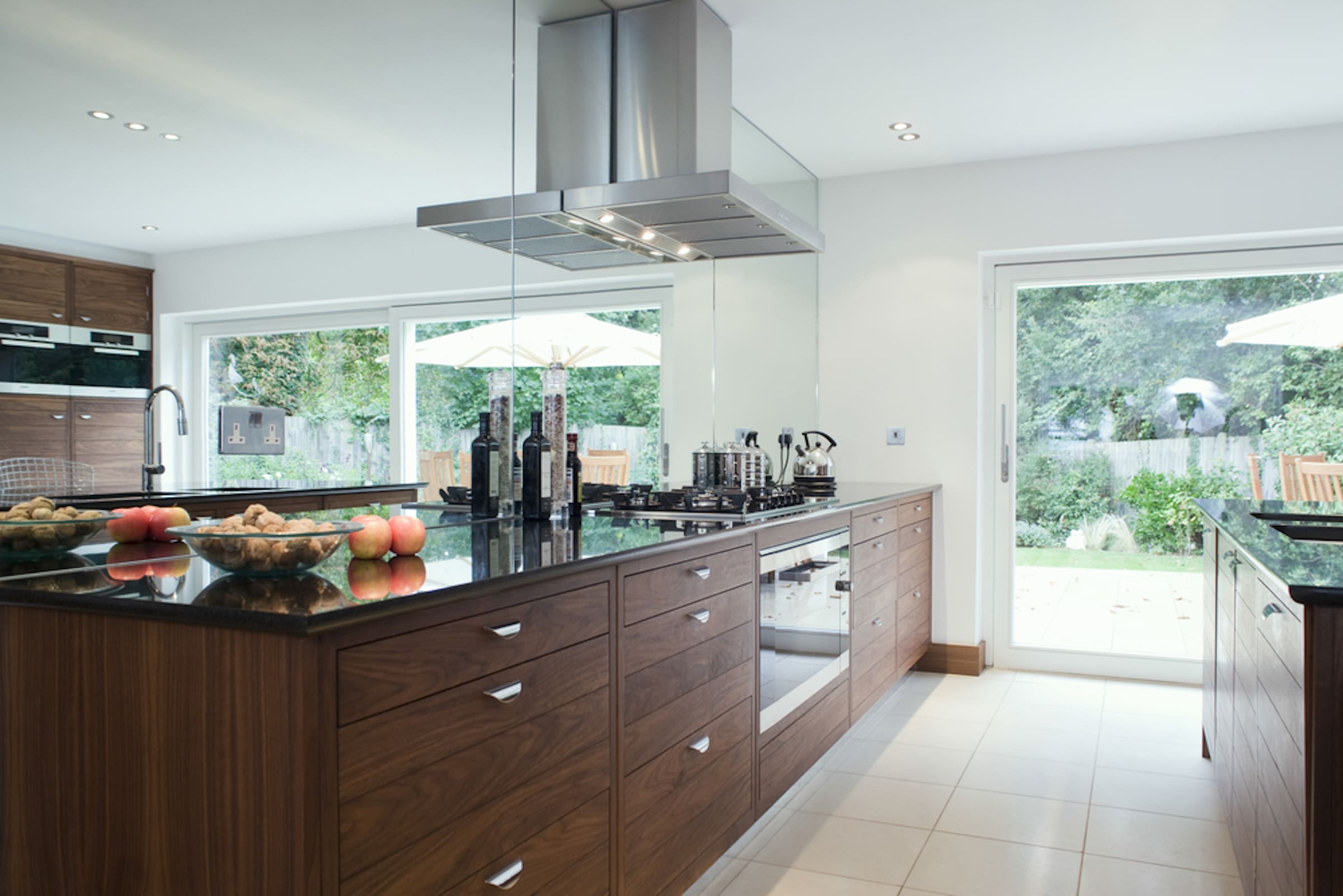 white Reynaers sliding patio doors in a kitchen renovation with oak units