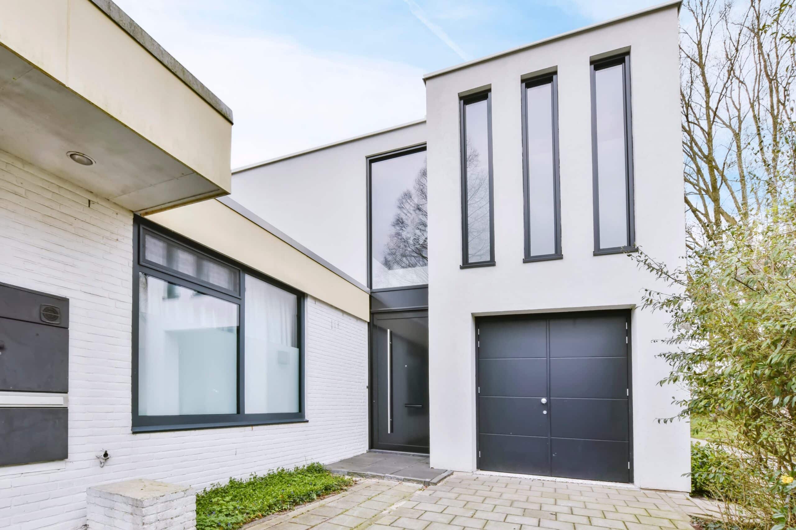 Schüco AD UP front door in a new modern white rendered house