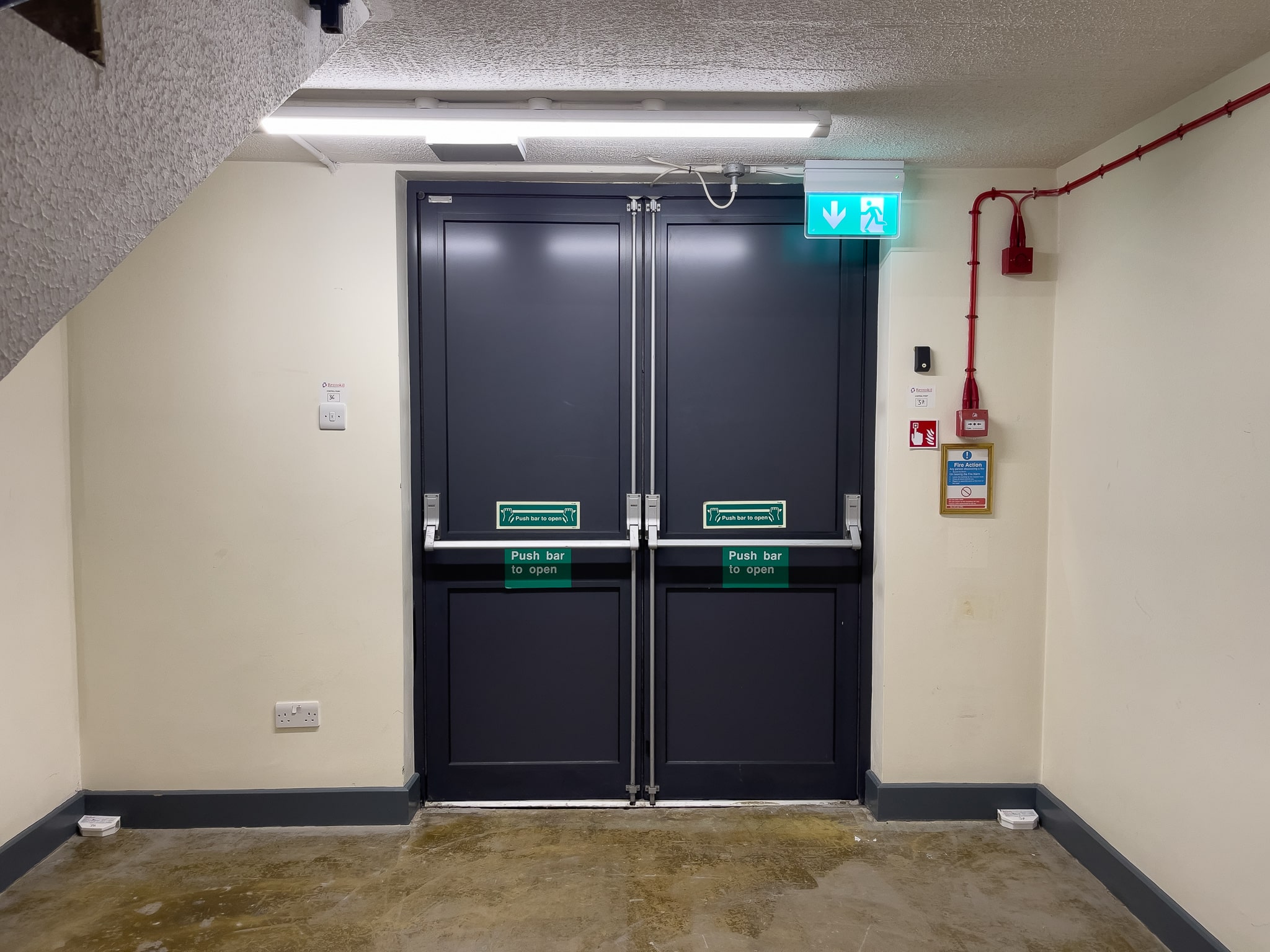 commercial aluminium doors with push to exit panic bars in a hotel corridor