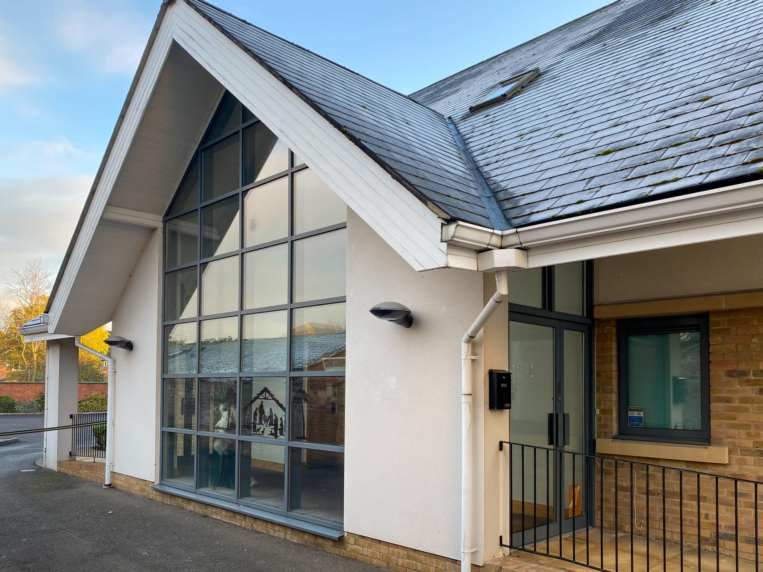 gable-shaped curtain walling to a leisure centre building with low pitch roof