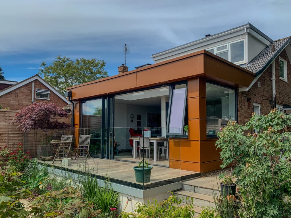 picture of the modern house with the extension on the back and green garden