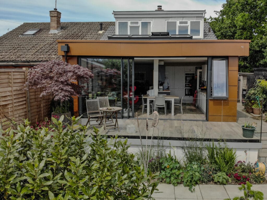 picture of the modern house with the extension on the back and green garden