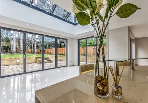 Alumil mf65 bifold doors in a kitchen extension with roof lantern above