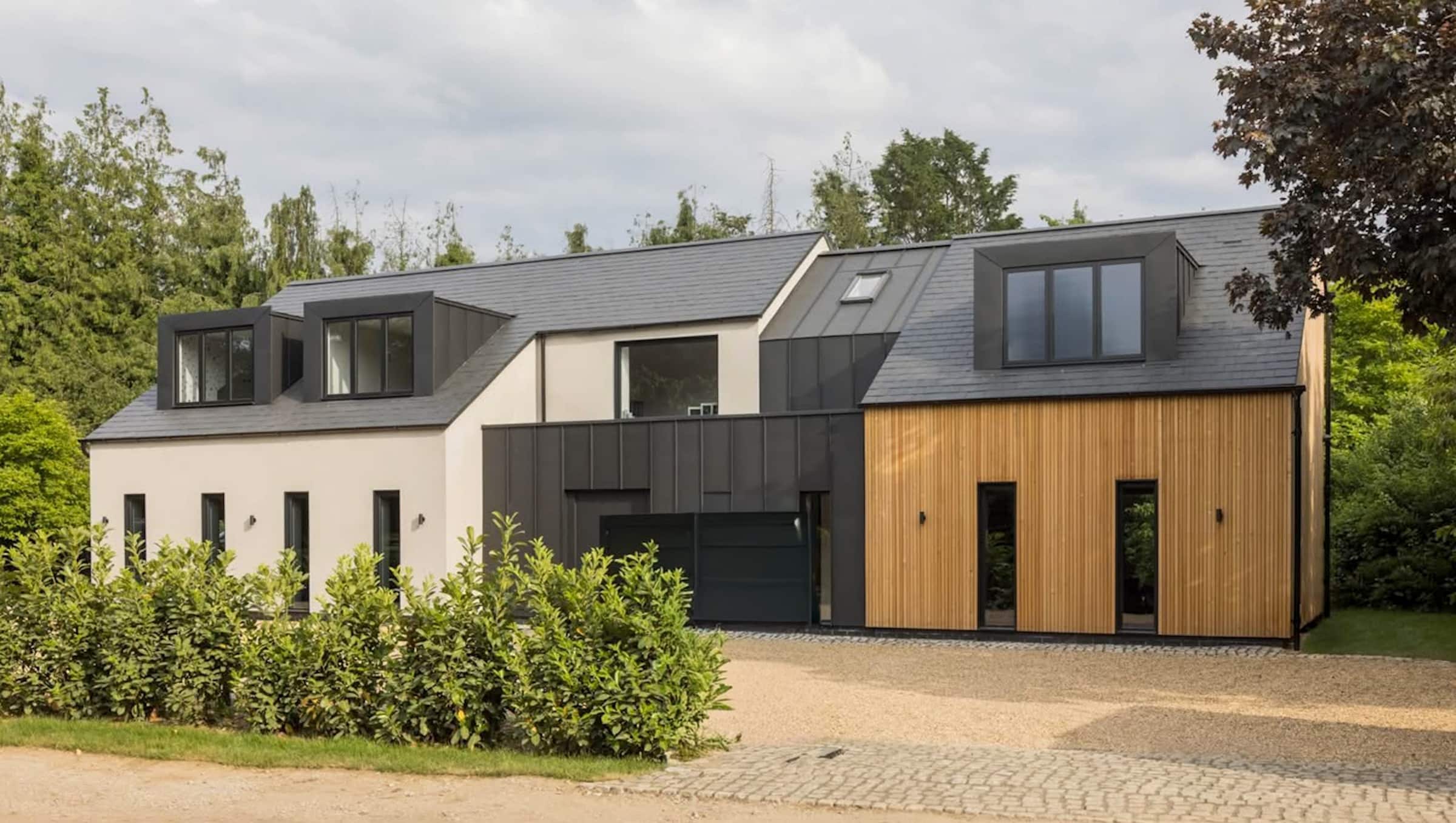 grey alumil s85 windows in a contemporary clad house with wood and metal caldding