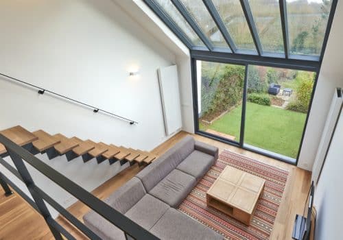 alumil smartia m450 sliding doors with roof looking down from balcony
