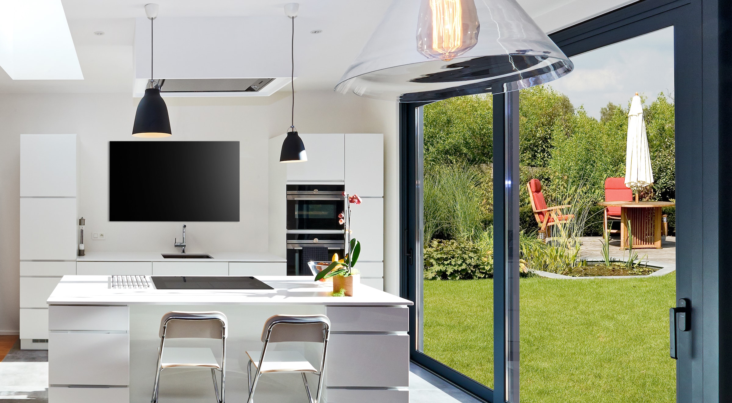 Open,Modern,Kitchen,From,Loft,With,View,On,A,Lush 630 phos lift and slide doors in a kitchen