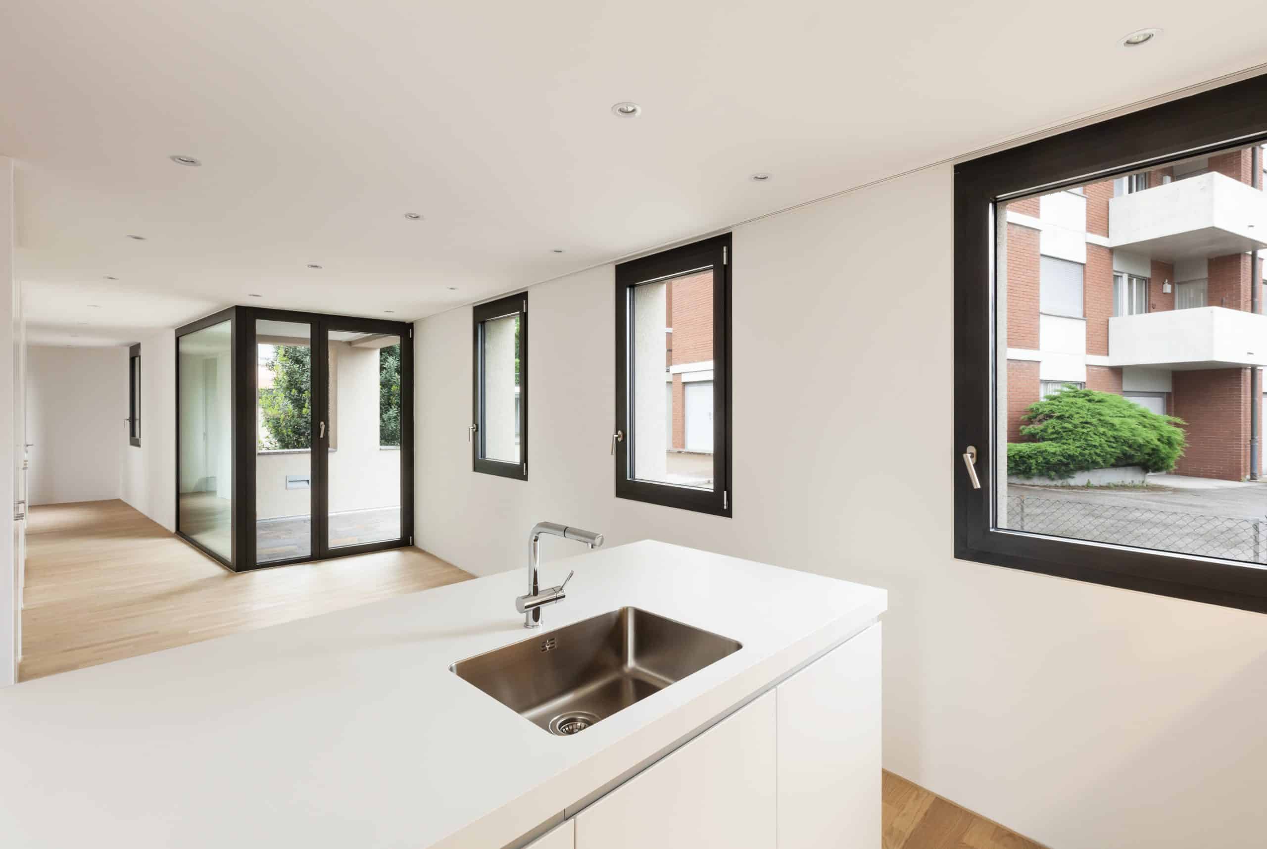 Alumil S77 tilt and turn windows in a kitchen renovation with apartment block views